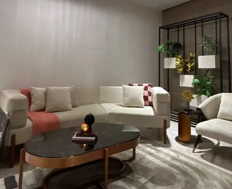 Elegant modern living room with a chic neutral sofa and lush plants.