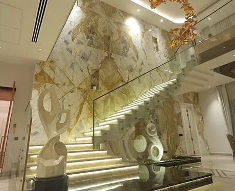 This breathtaking staircase has illuminated steps and marble walls.