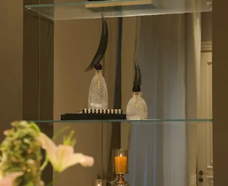 Elegant glass shelf display with stylish decor accents