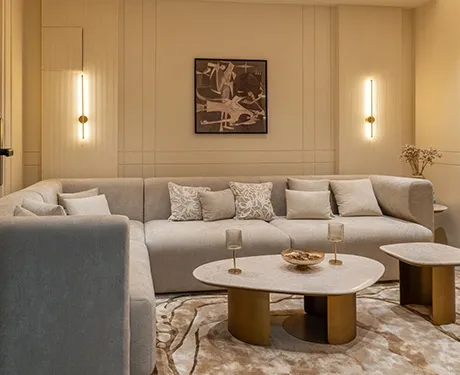 Elegant beige living room with curved sofa and warm lighting glow
